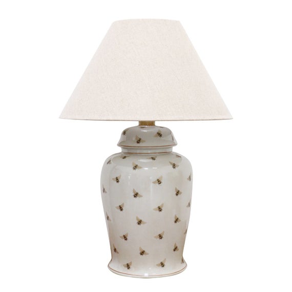 White ceramic lamp base with bee design.