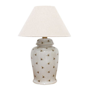 White ceramic lamp base with bee design.