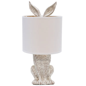 Rabbit shaped lamp with white/beige coloured fabric shade.