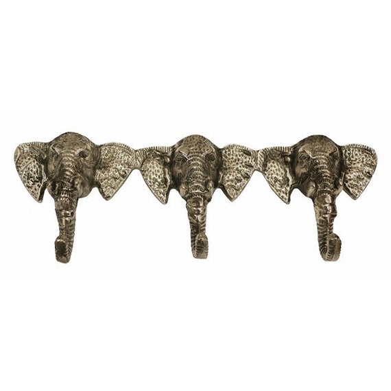 Set of three brass hooks in elephant head design.