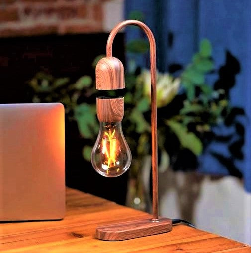 Desktop lamp in walnut colour with iridescent light bulb.