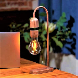 Desktop lamp in walnut colour with iridescent light bulb.