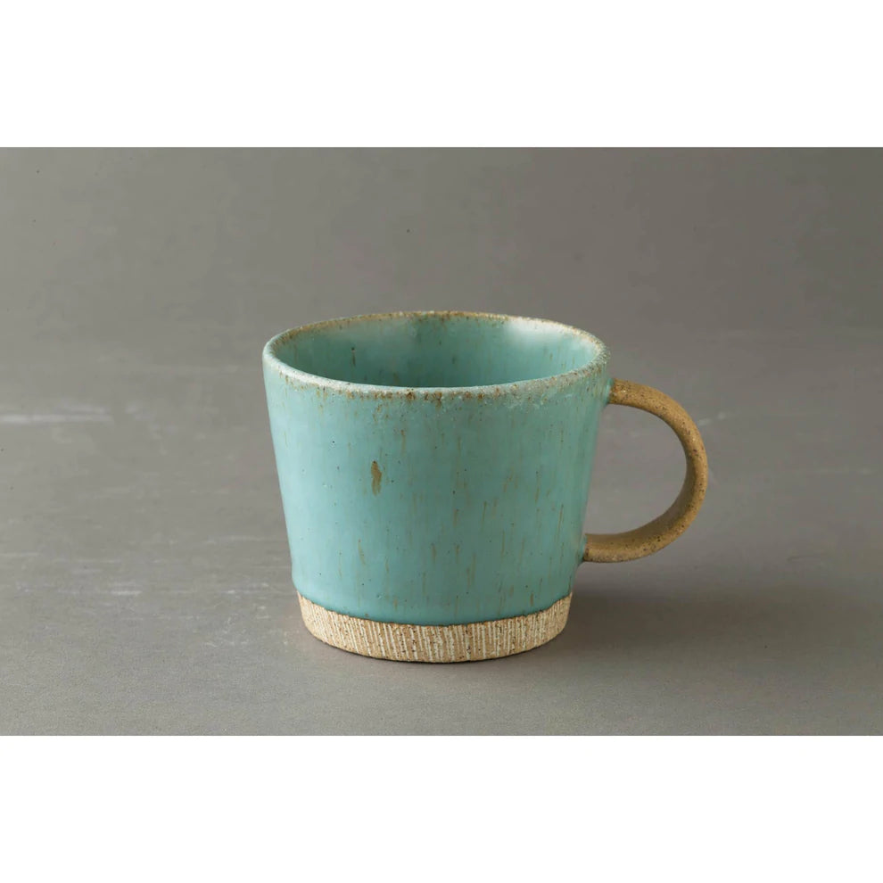 Turquoise colour pottery mug with brown coloured handle and base